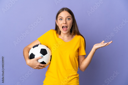 Young Lithuanian football player woman isolated on purple background with shocked facial expression © luismolinero