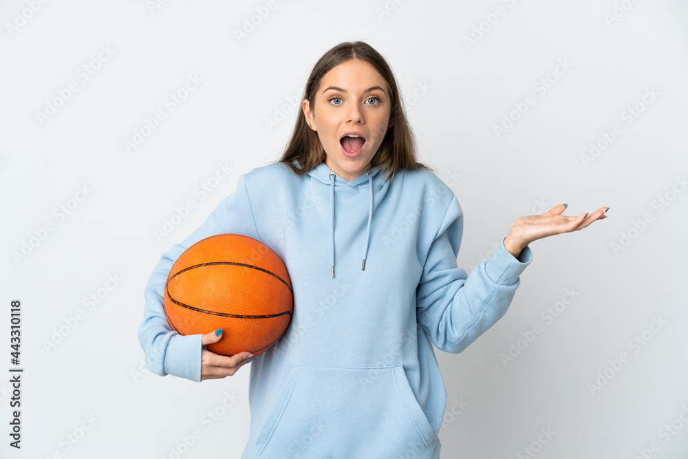 Young Lithuanian woman playing basketball isolated on white background with shocked facial expression Young Lithuanian woman playing basketball isolated on white background with shocked facial expression
