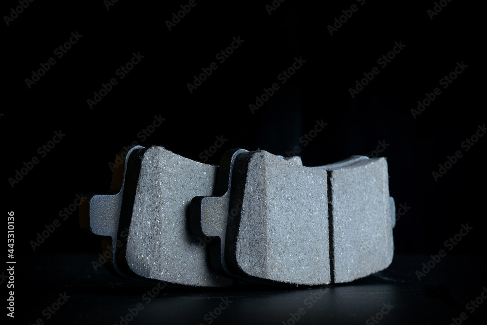 Obraz premium Car accessories. New metal car part. Auto motor mechanic spare or automotive piece isolated on black background. Technology of mechanical gear with space for text.