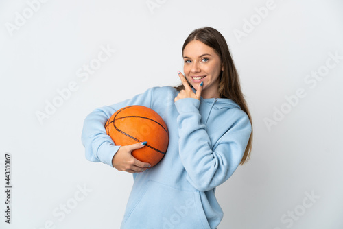 Young Lithuanian woman playing basketball isolated on white background happy and smiling