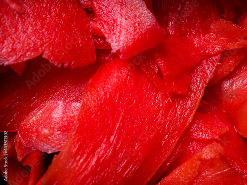 Close-up of red slices of fresh pickled ginger