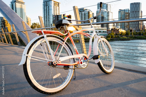 A vintage ladies cruiser bicycle parked on a pedestrian walkway over the Bow River in Calgary Alberta Canada. photo