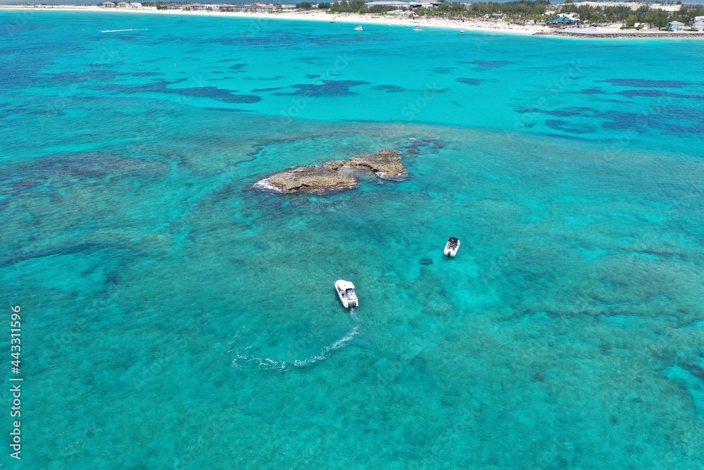 Aerial view of boats anchored near coral rocks off North Bimini, Bahamas on sunny summer afternoon. Aerial view of boats anchored near coral rocks off North Bimini, Bahamas on sunny summer afternoon.