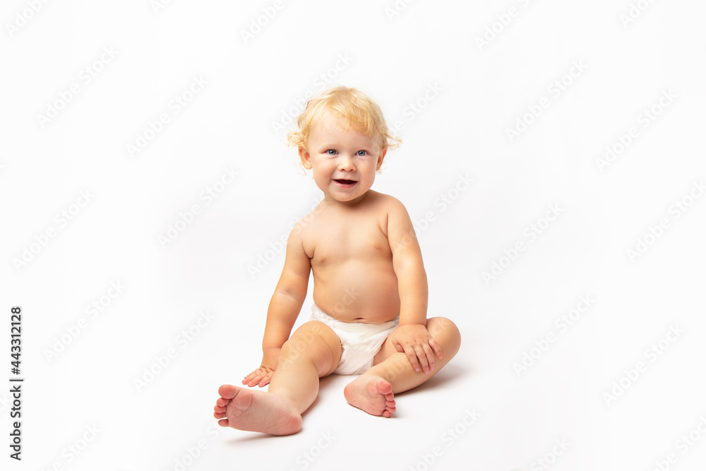 Infant child baby girl in diaper laughs happy looking at the camera isolated on a white background with copy space. baby care Infant child baby girl in diaper laughs happy looking at the camera isolated on a white background with copy space. baby care