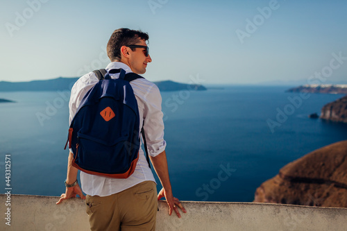 Εκτύπωση καμβά Santorini traveler man relaxing enjoying Caldera landscape view in Fira, Greece