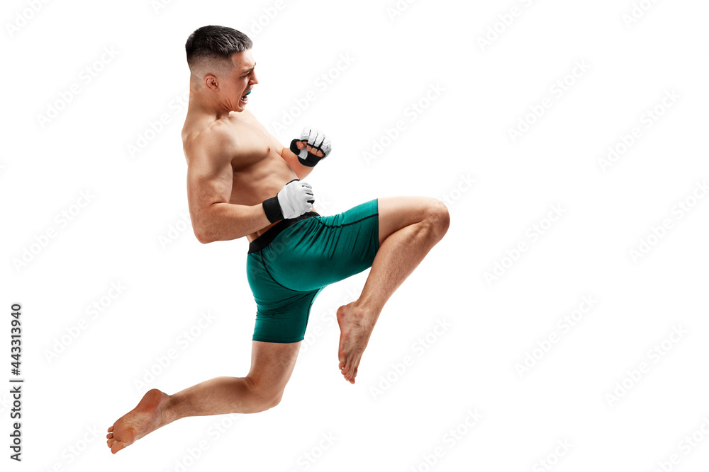 MMA. Jumping knee kick. Male fighter jumping with a knee kick. Sport. Isolated MMA. Jumping knee kick. Male fighter jumping with a knee kick. Sport. Isolated