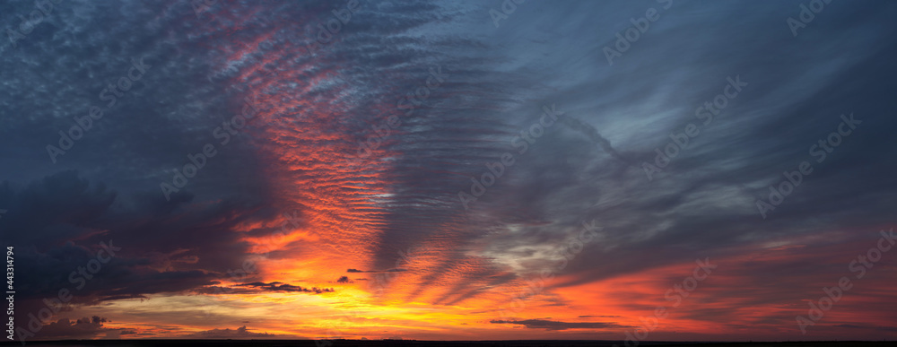 Beautiful atmospheric dramatic clouds in the evening at sunset. Panoramic image.
