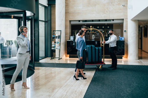Fototapeta People at the reception of a hotel checking in