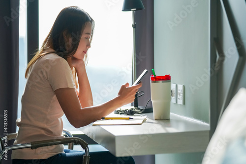 Asian woman using smartphone with internet for online shopping or social media. Female shopper enjoy purchase goods in online store with e-banking online payment on mobile phone application at home