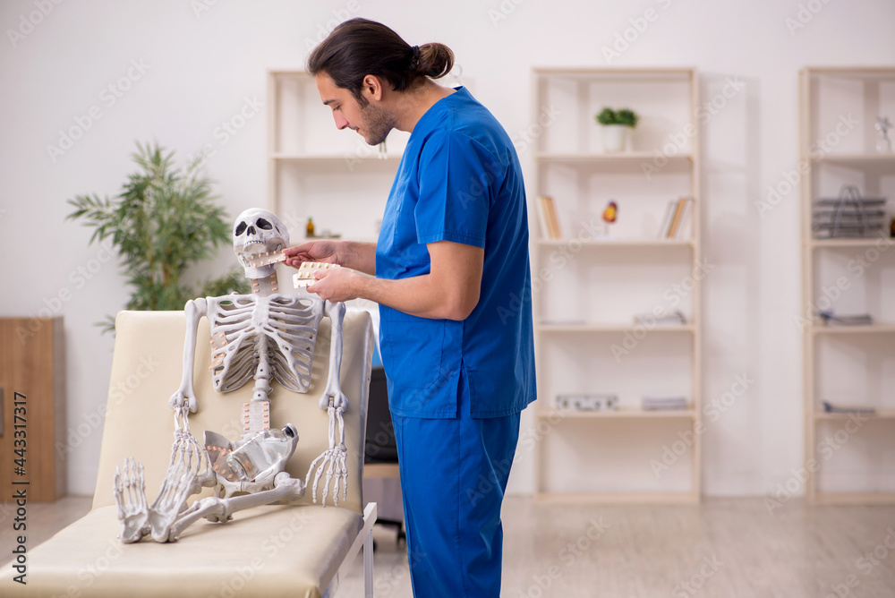 Young male doctor suggesting pills to skeleton patient Young male doctor suggesting pills to skeleton patient