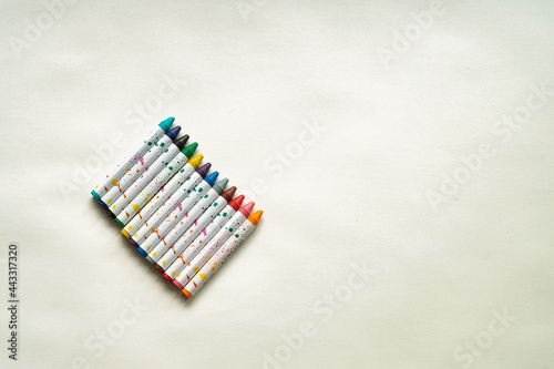   hildren s colorful drawing crayon chalks on the white background. Minimalistic wallpaper