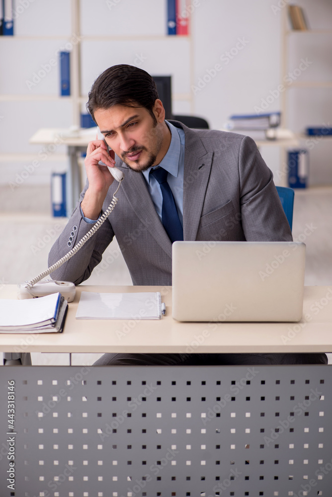 Young male employee working in the office Young male employee working in the office