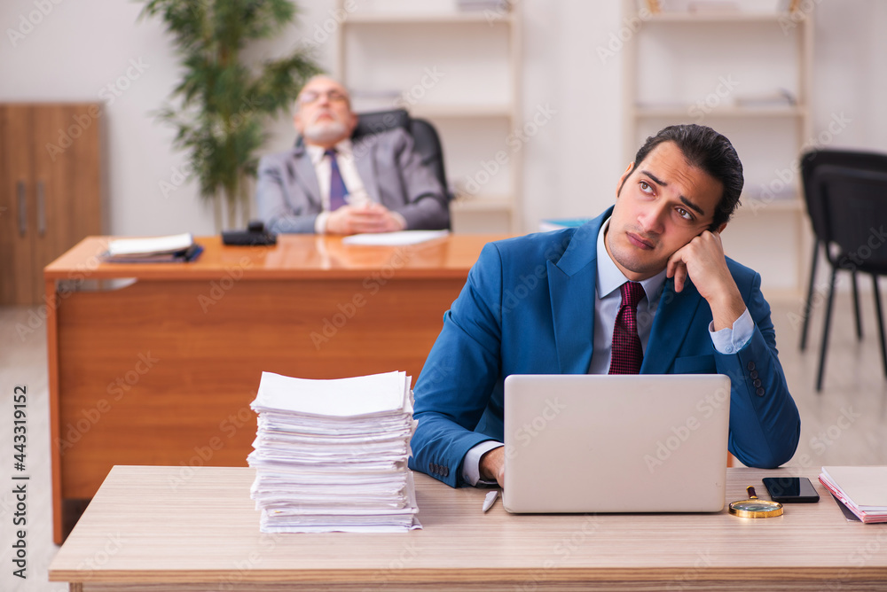 Two employees working in the office Two employees working in the office