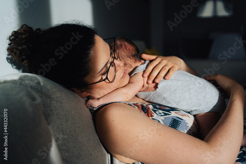 mother taking a nap with new born baby