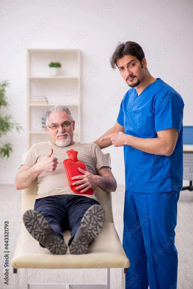 Fototapeta premium Old male patient visting young male doctor gastroenterologist