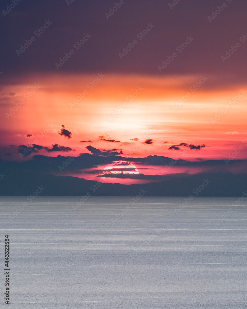 Sunset with Calm Sea and a Boat Sailing with Copy Space