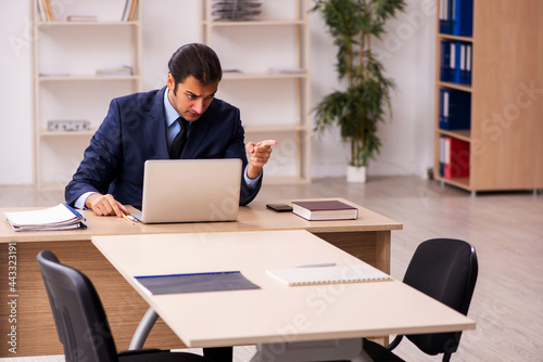 Young male employer sitting in the office