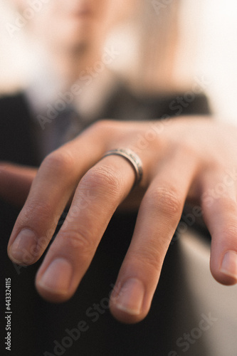 Close up of an elegant ring on manfinger. Outood shot with selective focus. photo