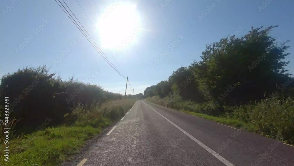 Sun shining directly into camera on an Irish road in summer Sun shining directly into camera on an Irish road in summer