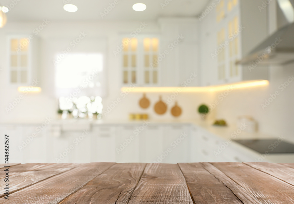 Empty wooden table and blurred view of stylish kitchen interior. Mockup for design Empty wooden table and blurred view of stylish kitchen interior. Mockup for design