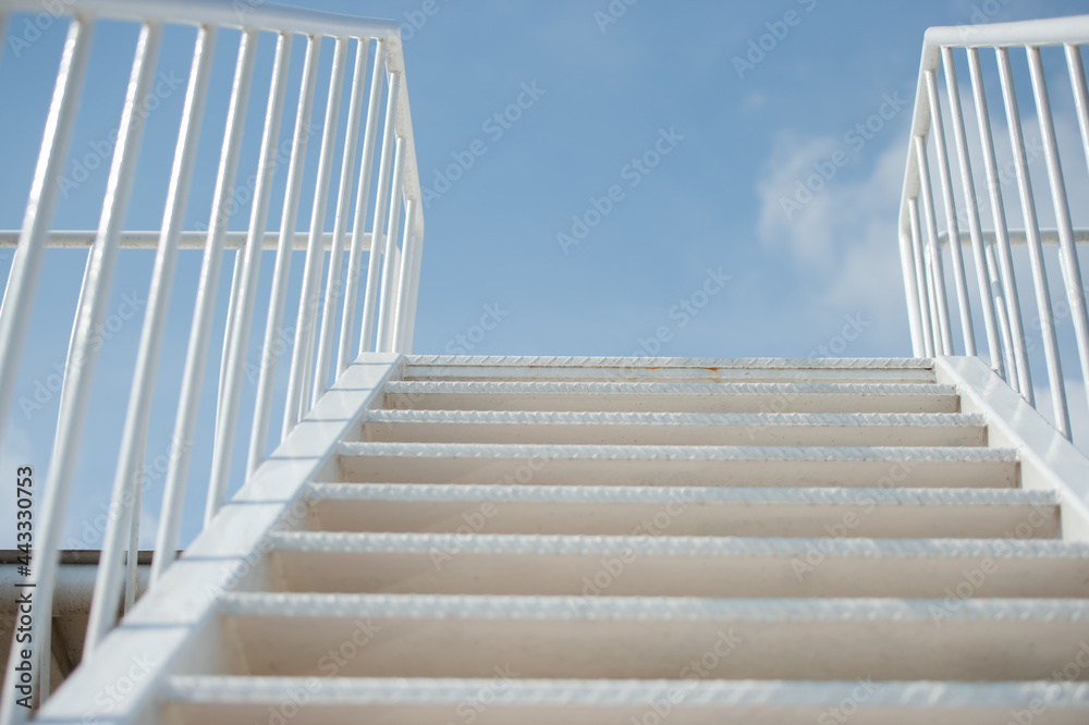 Fototapeta premium Stairs extending to the sky with thin clouds