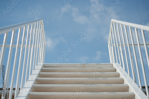 Stairs extending to the sky with thin clouds