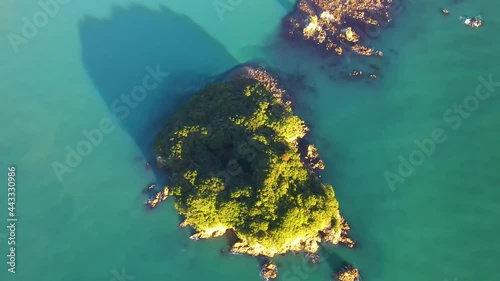 Picturesque View Of Whenuakura Island and Maukaha Rocks In Whangamata, New Zealand. aerial top-down photo