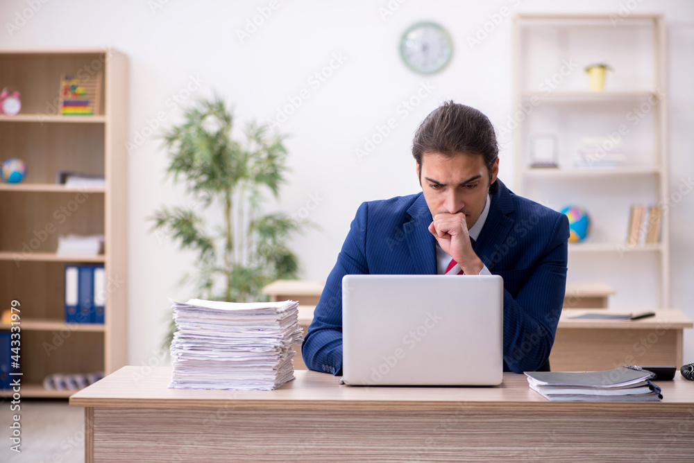 Young male employee sitting in the office Young male employee sitting in the office