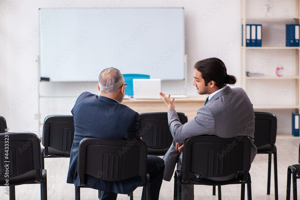 Two businessmen in the classroom in pandemic concept Two businessmen in the classroom in pandemic concept