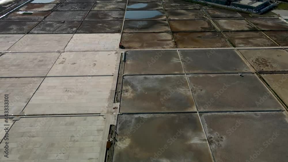 Slow close reverse drone flight next to a salt field in Croatia at daytime Slow close reverse drone flight next to a salt field in Croatia at daytime