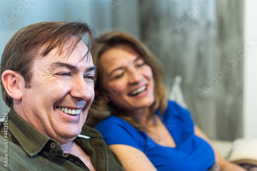Mature man and woman, smiling at home.