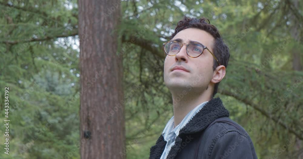 A man looking around a forrest A man looking around a forrest