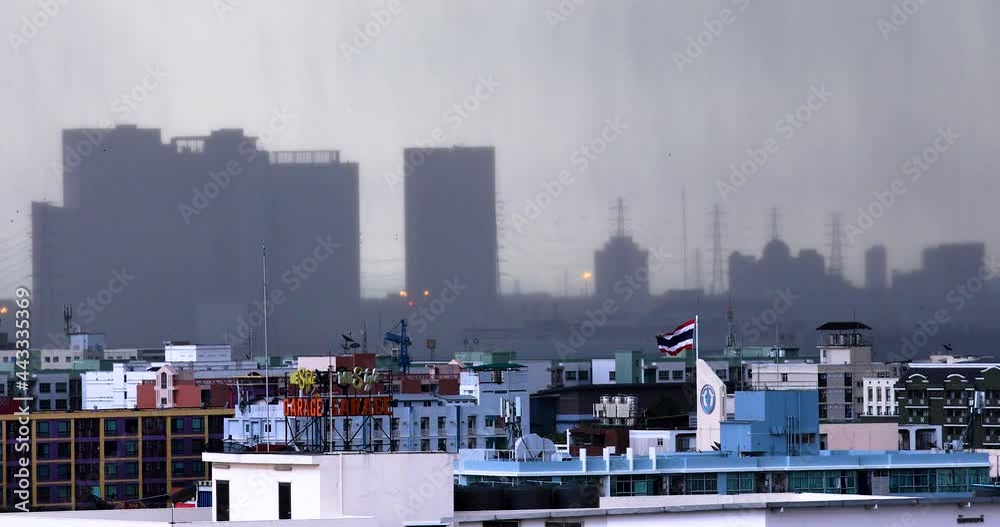 Monsoon Rain Falling with Buildings in the Distance During Heavy Rain Storm in the Capital City of Bangkok, Thailand. Monsoon Rain Falling with Buildings in the Distance During Heavy Rain Storm in the Capital City of Bangkok, Thailand.
