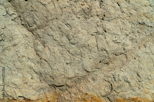 Close-up of uneven surface of a gray rock. Material for construction