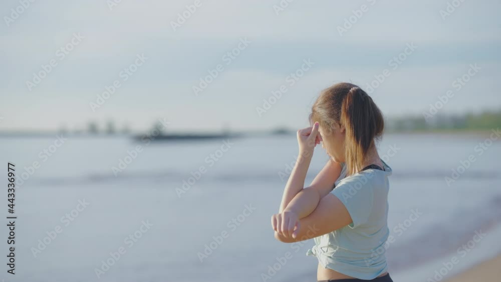 Asian cute girl She was walking and stretching before her morning run at the beach. and the sun shines, 4k resolution. Asian cute girl She was walking and stretching before her morning run at the beach. and the sun shines, 4k resolution.