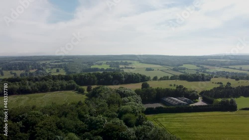 A rising shot of woodlands in 4K by a drone. photo