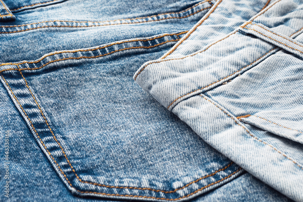 Close-up of the denim pockets, seams. Elements of denim clothing. Jeans background for sewing. Natural, durable denim fabrics Close-up of the denim pockets, seams. Elements of denim clothing. Jeans background for sewing. Natural, durable denim fabrics