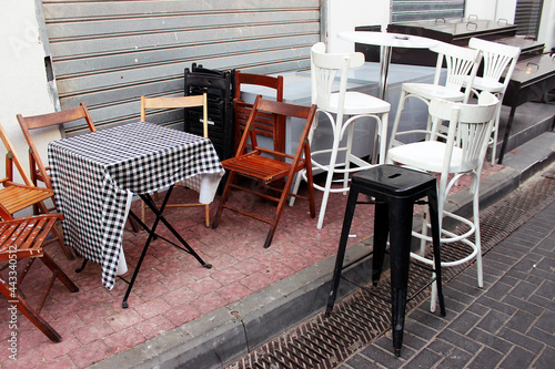 A closed cafe before Shabbat near a cafe in the Carmel market area in Tel Aviv, Israel. Tables and chairs before Shabbat.