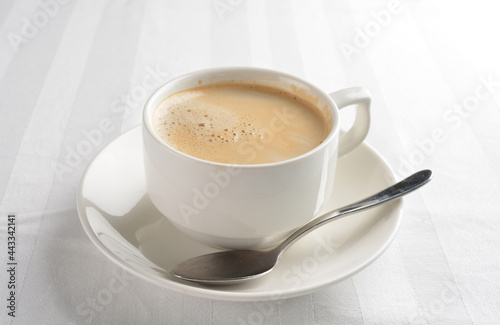 a cup of hot cafe coffee with fresh milk on white background halal beverage menu