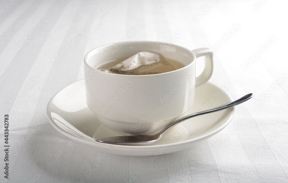 a cup of hot green tea leaf in bag on white background halal beverage menu a cup of hot green tea leaf in bag on white background halal beverage menu