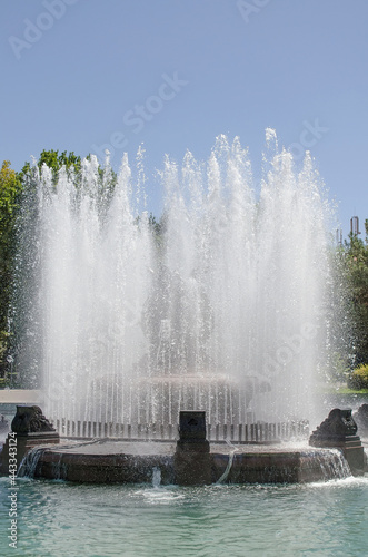 Wallpaper Mural Tall fountain in the park inside a pool of water in front of green trees and blue sky Torontodigital.ca