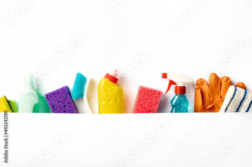 Set of various cleaning supplies on white background with copy space, top view