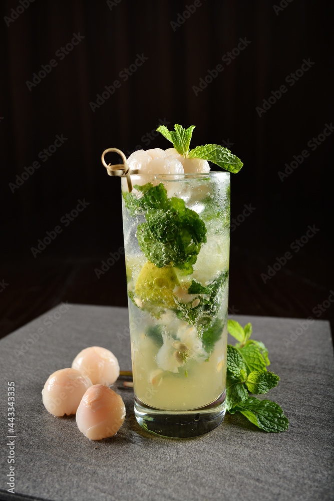 iced lychee longan mint fizz mocktail with mint leaf kombucha in glass