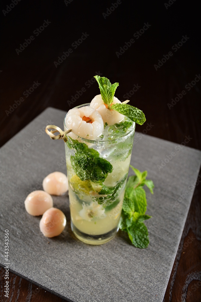 iced lychee longan mint fizz mocktail with mint leaf kombucha in glass