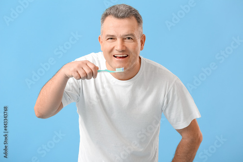 Mature man brushing teeth o...