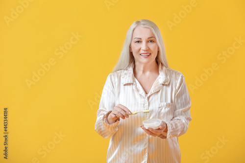 Mature woman brushing teeth...
