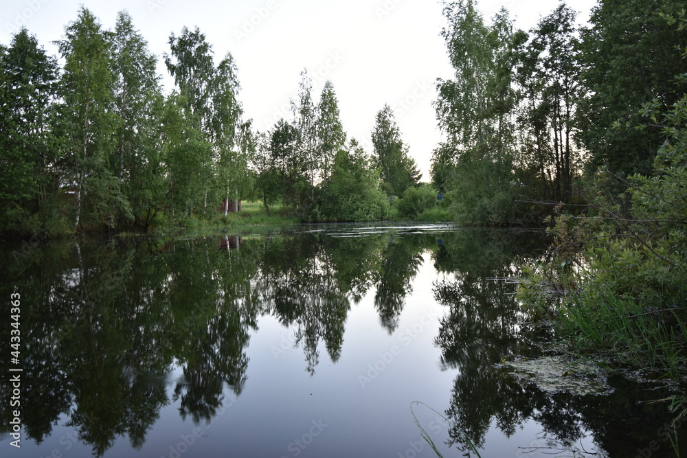 lake in the village in the evening