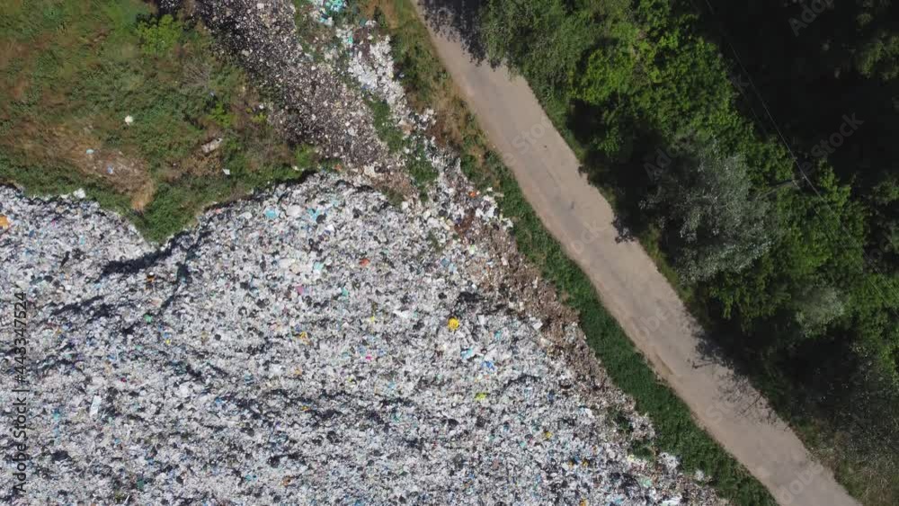 Aerial view of huge rubbish dump. Trash and garbage landfill. Ecology problem, nature pollution. Consumerism economy cons. Aerial view of huge rubbish dump. Trash and garbage landfill. Ecology problem, nature pollution. Consumerism economy cons.