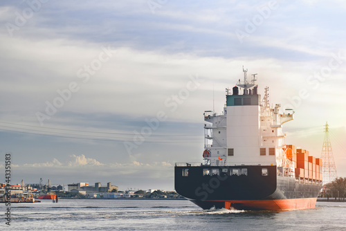 Back view container cargo ship, import export commerce business trade logistic and transportation of International by container cargo ship boat in the open sea, Freight shipping maritime.