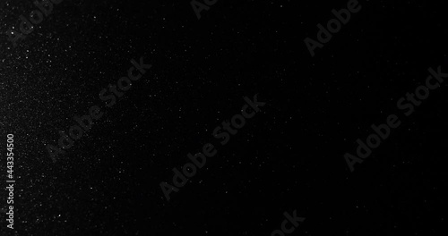 Silver glitter black sand or diamond dust creating abstract shimmering glow formations blinking  metamorphosis. Art background texture glamour